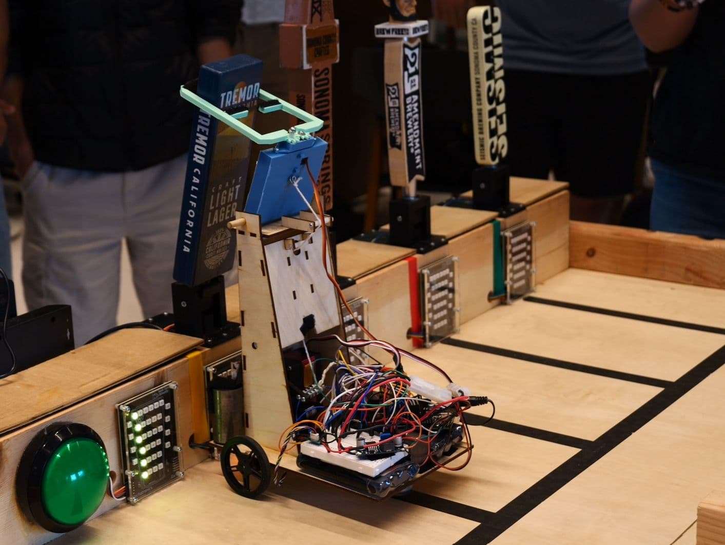 Robot arm pulling a bar tap during the competition task